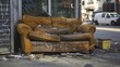 © Lasvu - Discarded damaged couch outside store