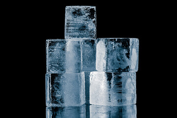 Wall Mural - A group of three ice cubes, isolated on a black background.