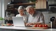 © Lion - Senior couple using online recipe on laptop modern kitchen clean layout copy space