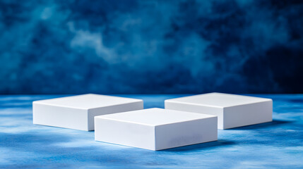 Wall Mural - Square podiums are white. Abstract background. A stage for the demonstration of cosmetics. Podium for the award, consisting of three 3 square figures of different sizes on a blue background. Showcase