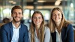 © Tondone - Three young professionals sit together, smiling in a modern office environment. Their outfits and cheerful expressions convey teamwork, positivity, and a collaborative spirit.