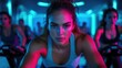 © Oktyabrskiii - Engaging group cycling session in a vibrant studio with energetic lighting and focused participants