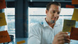 © Summit Art Creations - Portrait of professional male leader writing marketing idea on sticky notes. Caucasian businessman thinking about marketing campaign while using colorful sticky notes at glass wall. Manipulator.