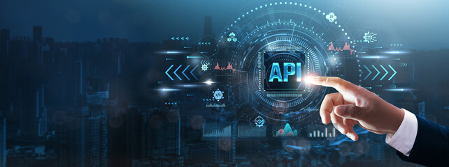 api: businessman’s hand touching futuristic technological interface, application programming interfa