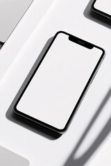 Poster - Modern smartphone showing blank screen lying on white desk