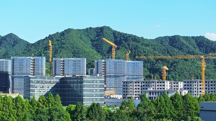 Wall Mural - Aerial shot of construction site with buildings under construction and cranes at day