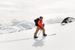© fesenko - Confident skier skis up a gentle slope, laying his skis on white untouched snow