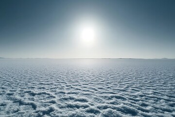 The stark white of a salt flat illuminated by a harsh midday sun, creating a mirror-like effect on the horizon.