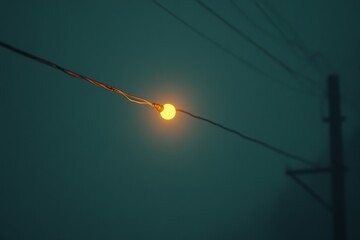 Aufkleber - Soft glow of vintage light bulb illuminating foggy evening streets with power lines in the background during twilight hours