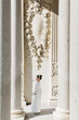 © ADDICTIVE STOCK - Girl in elegant First Communion dress amidst grand architecture