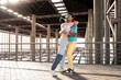 © ADDICTIVE STOCK - Happy gay couple embracing at modern train station under sunlight