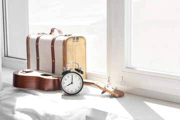 Wall Mural - Alarm clock, ukulele and suitcase on windowsill in bedroom