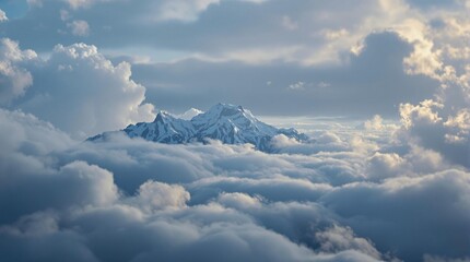 Fototapete - Snow-Capped Mountain Rising Above a Sea of Clouds on a Bright Sunny Day, with Partial Clouds and Blue Sky