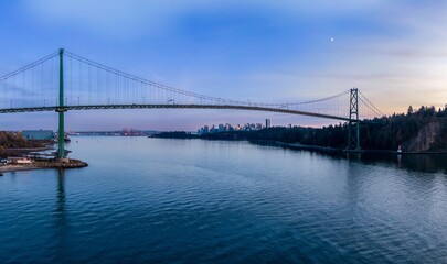 Poster - Panoramic view of the Lions Gate Bridge at twilight. City skyline reflected in the calm waters. Beautiful evening light.  Vancouver, British Columbia, Canada