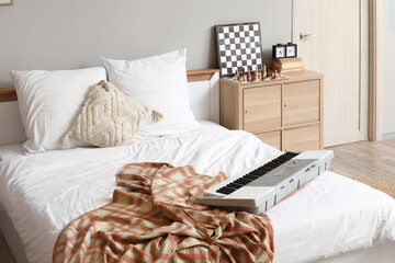 Wall Mural - Interior of teenager's room with bed, synthesizer and drawers