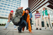 © Jose Calsina - Energetic Breakdancer Showcasing a Skillful Freeze Move while Friends Support and Cheer him on during an Exciting Street Dance Performance with Enthusiasm and Passion for hip hop Culture.