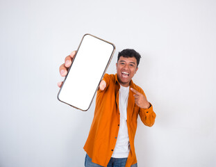 Handsome young Asian man wearing casual shirt showing smart phone with blank screen isolated on white background