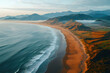 © Muh Saleh - Coastal sunrise, sandy beach, mountains, ocean waves. Travel website, tourism