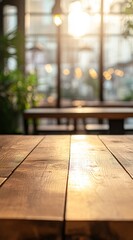 Wall Mural - Empty wooden table in a sunlit cafe.