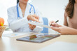 © NanSan - A young female nutritionist expert talks to a female patient at a table, recommending a healthy diet with vegetables and fruits to promote wellness, balanced nutrition, and effective weight loss
