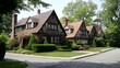 A street view of twin houses with similar design, featuring large windows, a shared driveway, and neatly trimmed lawns.