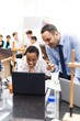 © Rawpixel.com - Teacher and student in a science class. Male teacher, female student. Engaged in learning, science experiment, and computer work. Classroom setting, diverse group. Students and education concept.