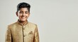 © gn8 - Young boy in traditional south asian attire smiling against neutral background for cultural celebration