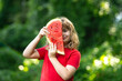 © Volodymyr - Happy Kid with watermelon. Funny kid eating watermelon outdoors in summer park. Child, baby, healthy food. Child eating watermelon in the garden. Kids eat fruit outdoors. Kid enjoying watermelon.