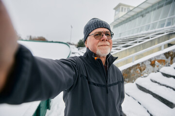 Wall Mural - Senior Man Taking a Selfie Outdoors in Winter