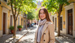 © Alex_Kalin - Smiling woman in trench coat on historic street, urban charm