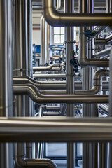Aufkleber - Complex arrangement of metallic pipes in industrial setting