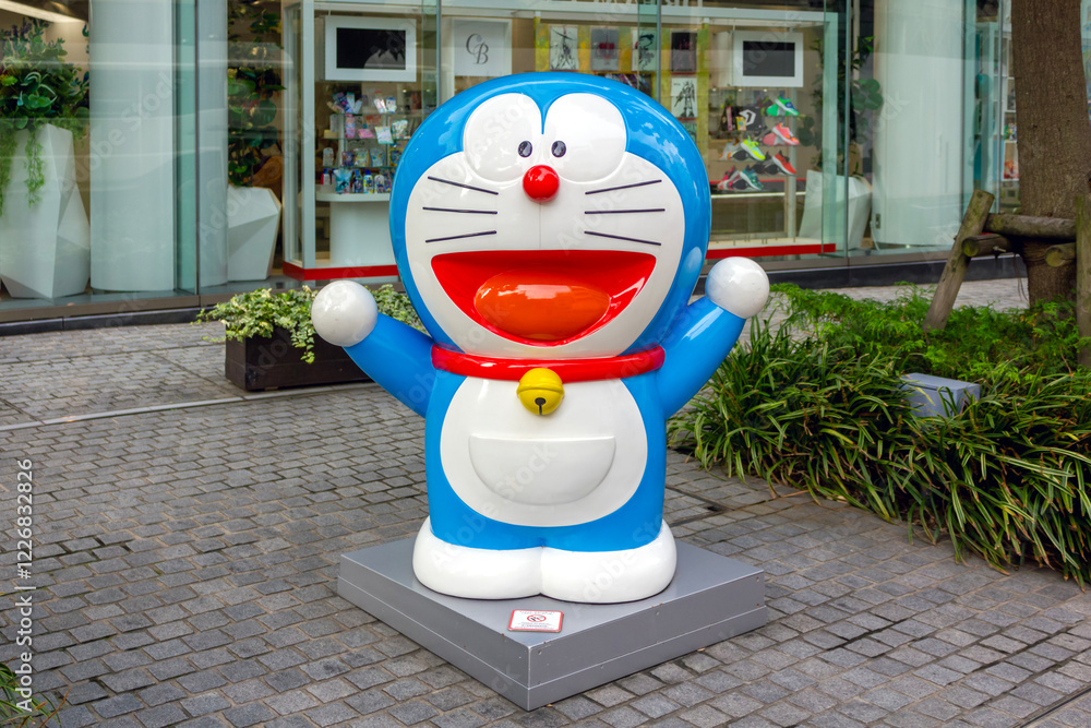 Tokyo, Japan - November 15, 2024: A cheerful statue of Doraemon, the ...