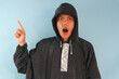 © Lailar Studio - Asian man wearing black raincoat with shocked expression