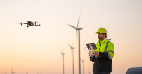 Wall Mural - engineer specialists pilot drone on wind turbine farm. architectural engineer and safety engineering