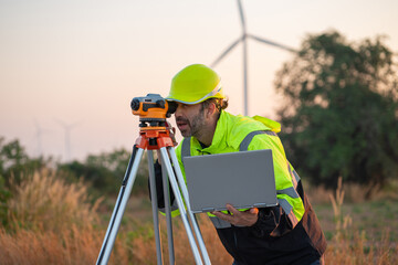 Wall Mural - engineer with laptop survey work in wind turbine farms rotation to generate electricity energy. main