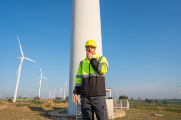 Wall Mural - engineer wearing uniform inspection and survey work in wind turbine farms rotation to generate elect