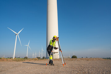 Wall Mural - engineer wearing uniform inspection and survey work in wind turbine farms rotation to generate elect