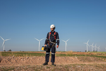 Wall Mural - engineer wearing uniform inspection and survey work in wind turbine farms rotation to generate elect