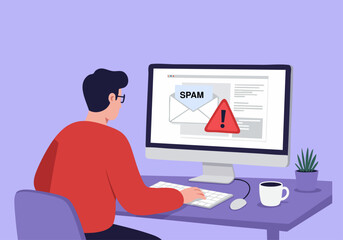 a person receives an email warning about spam on their computer screen, highlighting digital securit