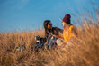 © Zoran Zeremski - Two woman sitting at top of the hill at meadow resting after hiking.