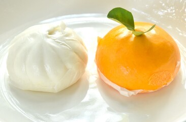 Wall Mural - Chinese steamed bun stuffed sweet orange and salty chop pork on plate