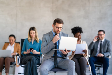 Canvas Print - Multicultural professional businesspeople working together on research plan in boardroom.