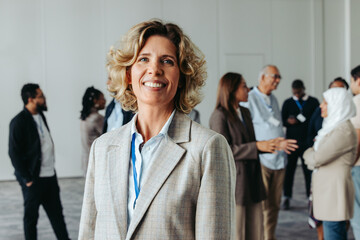 Wall Mural - confident mature businesswoman at networking event with successful professionals