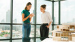 © Summit Art Creations - Young beautiful architect team discuss about house construction while standing near at window with city view and sky scrapper. Group of interior designer sharing, brainstorming idea. Tracery