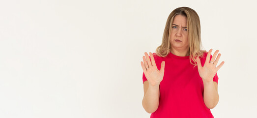 Portrait of young woman making stop sign in front of the camera.