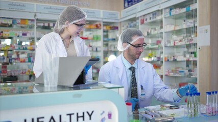 Wall Mural - Pharmacist and chemical scientist doing antibiotic trials and testing in the laboratory