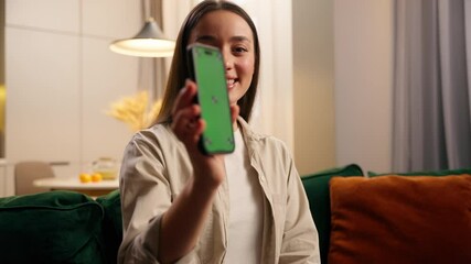 caucasian woman female lady girl at home relaxing at couch holding mobile phone smiling browsing soc