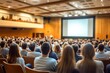 © Gophotograph - A vibrant business conference takes place in a modern auditorium.