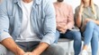 © Katewaree - Healthcare setting, a young man remains calm and relaxed as his friends share a social moment, capturing the essence of everyday life in a waiting room