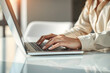 © Sync - Close-up of Businesswoman Hands Typing on Laptop Computer Keyboard in Modern Office, Freelancer or Business Professional Working on Internet Connection Technology with Natural Light Reflection on Desk